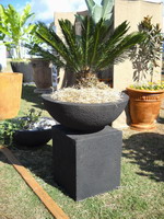 Semi formal finish bowl and plinth feature planter. Charcoal finish.