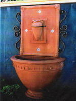 Tuscan style courtyard water feature, roman pot wall plaque, angelica half wall pot and base, aged terracotta semi formal finish