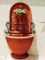 Tuscan style courtyard water feature, roman woman imogen wall plaque with forged iron scrolls, angelica half wall pot, aged terracotta semi formal finish