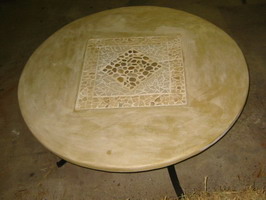 Custom round garden table, Mottle Ivory rust finish with lava stone relief, on wrought iron base