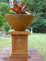 Large lava stone finish bowl on recessed panelled plinth with Rust Verdi volcanic scoria finish